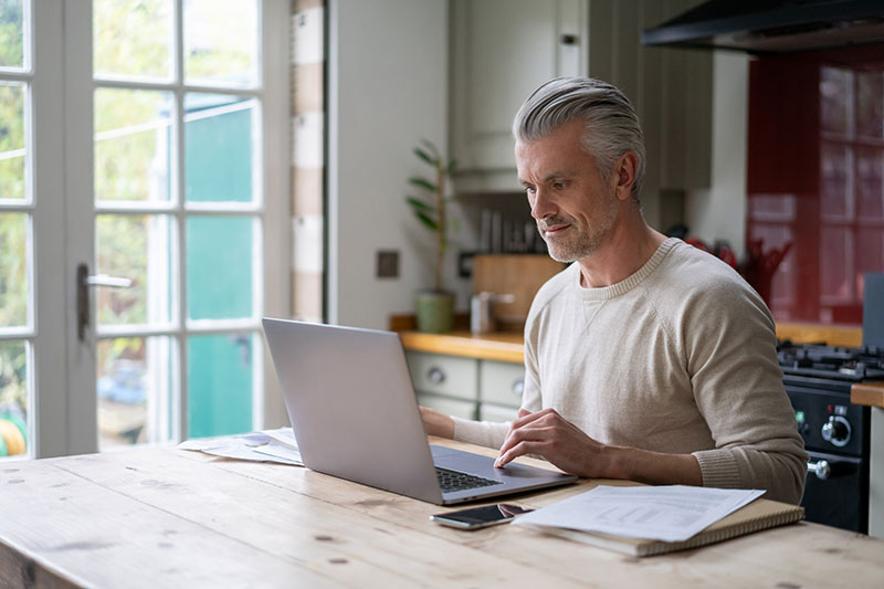 The best home contractor, man on a laptop looking up contractor